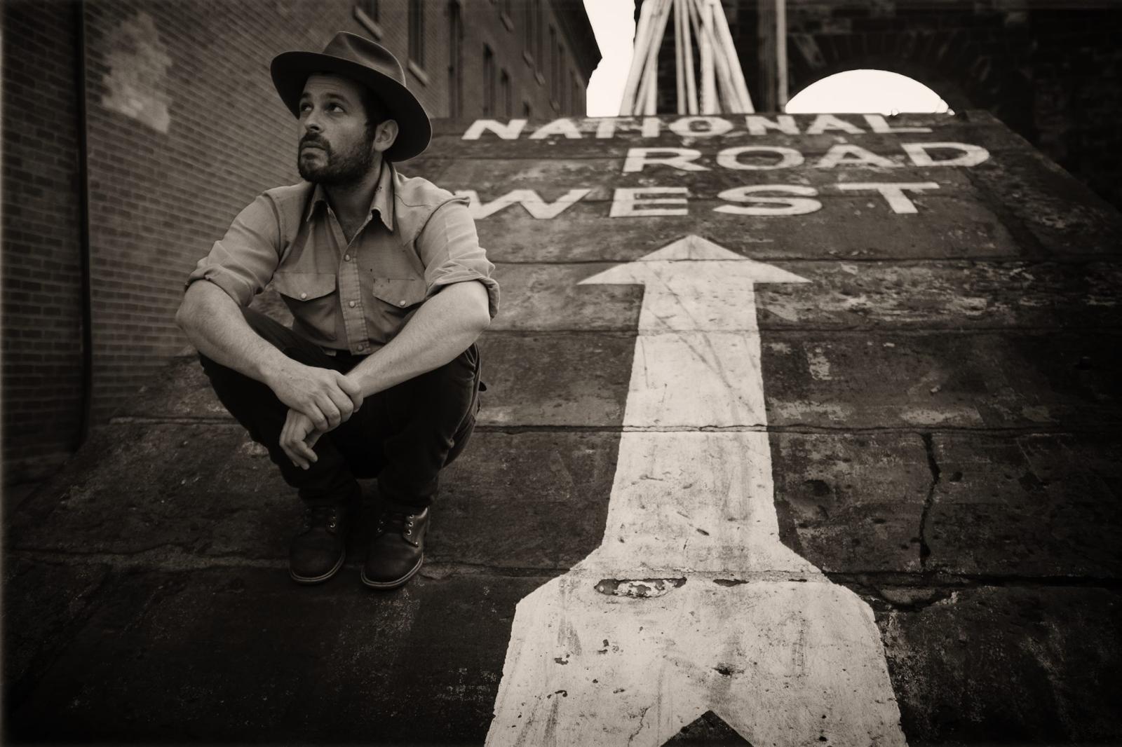 Gregory Alan Isakov sitting on the ground