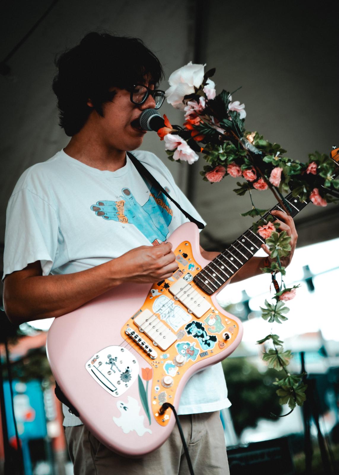 Cesar playing guitar and signing at UMS